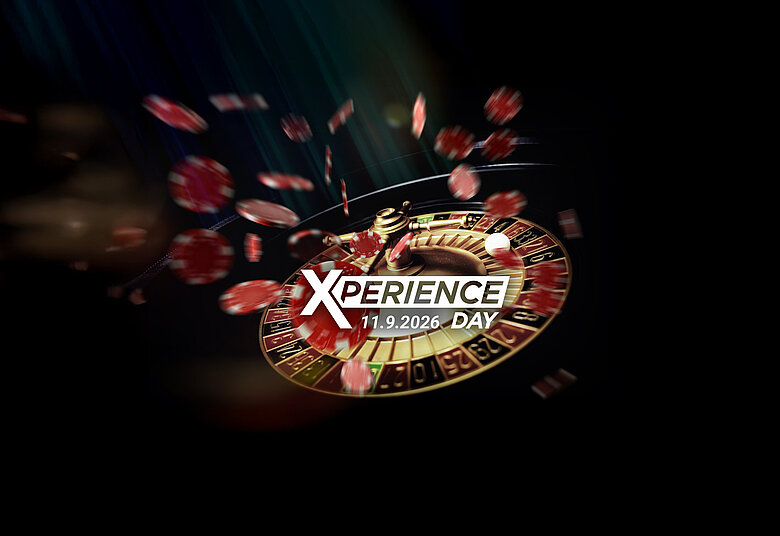Roulette-Kessel mit fliegenden Jetons auf dunklem Hintergrund Xperience Day Key-Visual