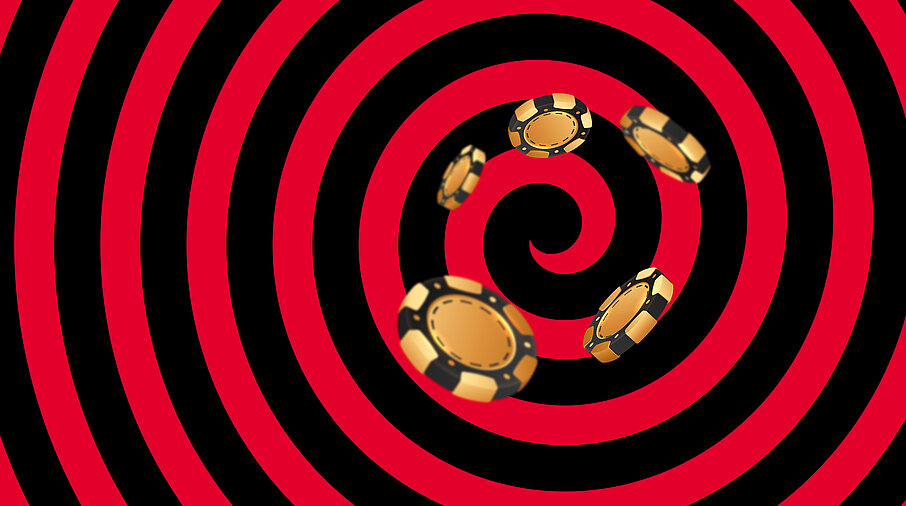 Gold-schwarze Casino Jetons auf schwarz-rotem Hintergrund