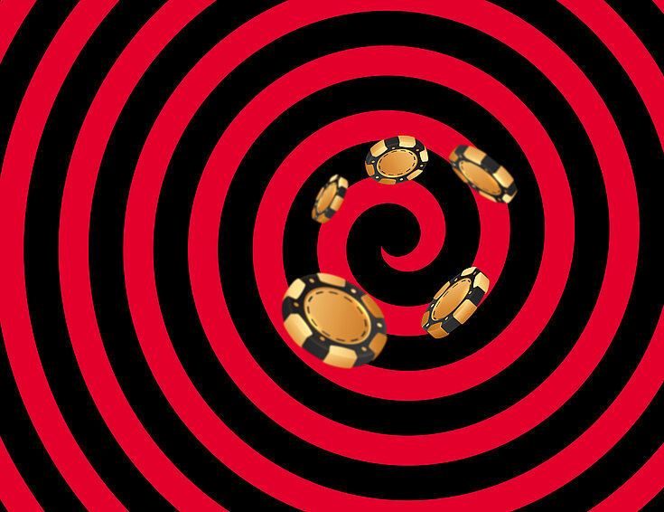 Gold-schwarze Casino Jetons auf schwarz-rotem Hintergrund