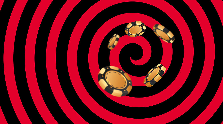 Gold-schwarze Casino Jetons auf schwarz-rotem Hintergrund