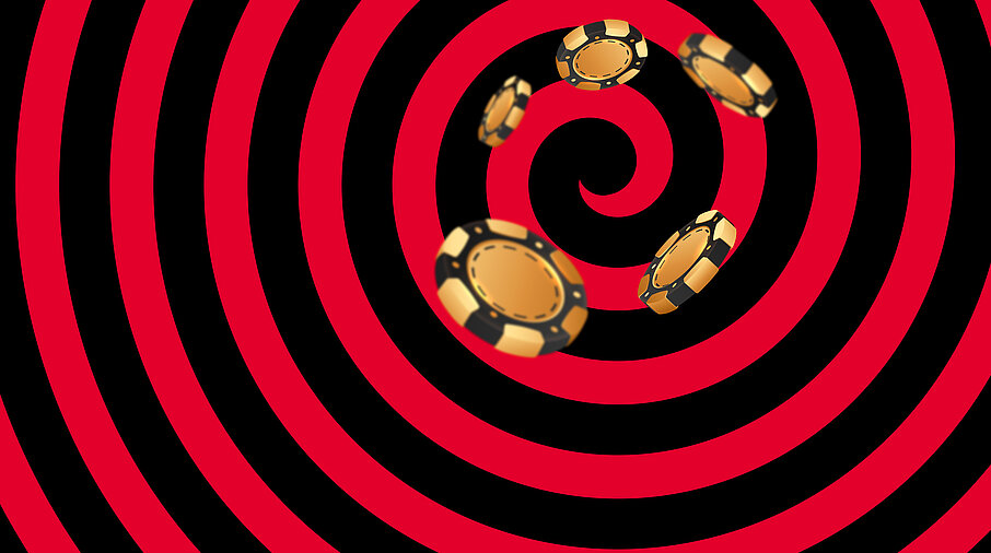 Gold-schwarze Casino Jetons auf schwarz-rotem Hintergrund