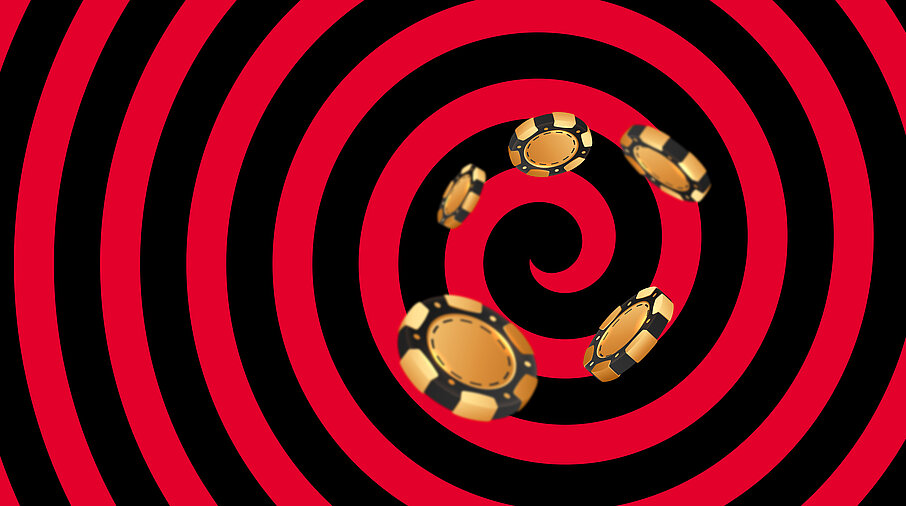 Gold-schwarze Casino Jetons auf schwarz-rotem Hintergrund