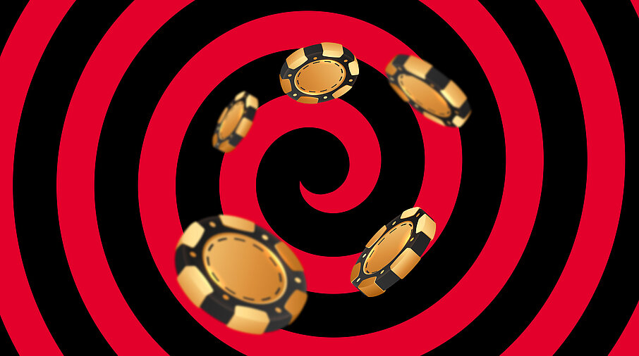 Gold-schwarze Casino Jetons auf schwarz-rotem Hintergrund